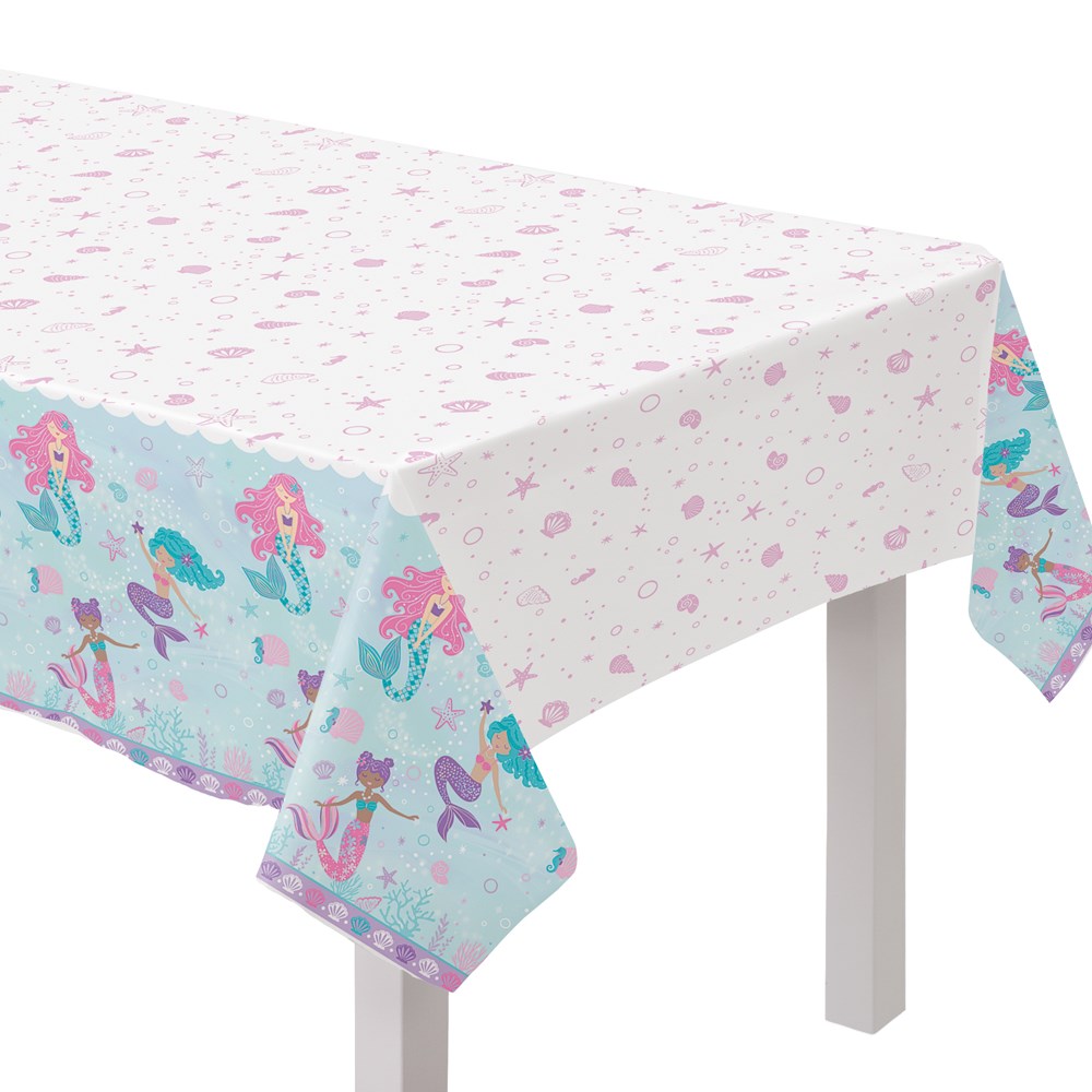 Plastic table cover with shimmering mermaid illustrations on blue and white background, 54x96 inches.