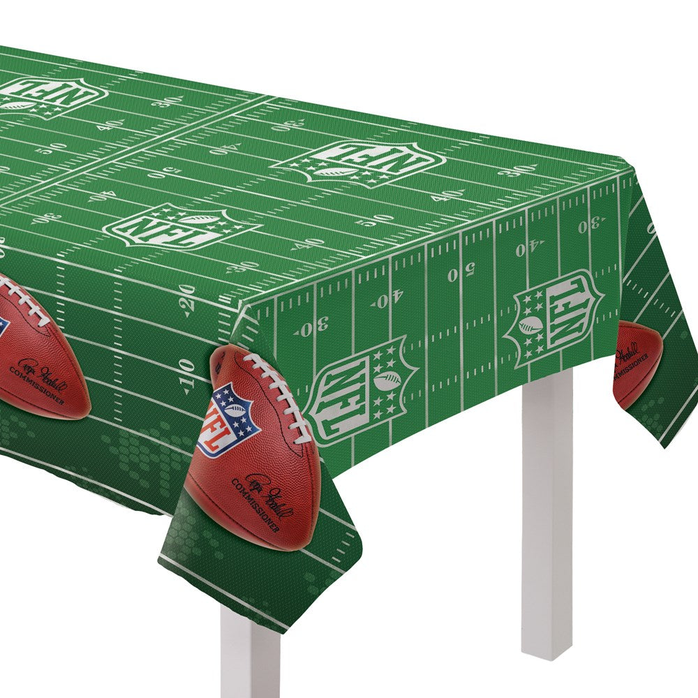 Green rectangular plastic table cover with white football field markings and NFL logos, featuring brown football graphics at