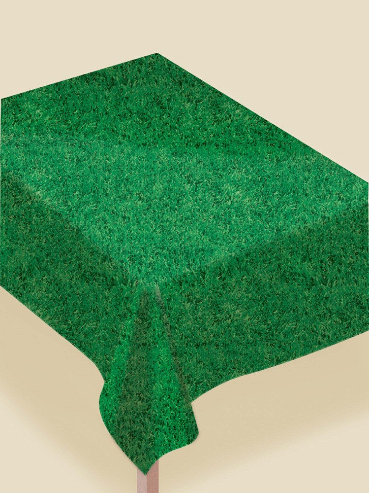 Rectangular table covered with a vibrant green faux grass textured plastic tablecloth with a flannel back.
