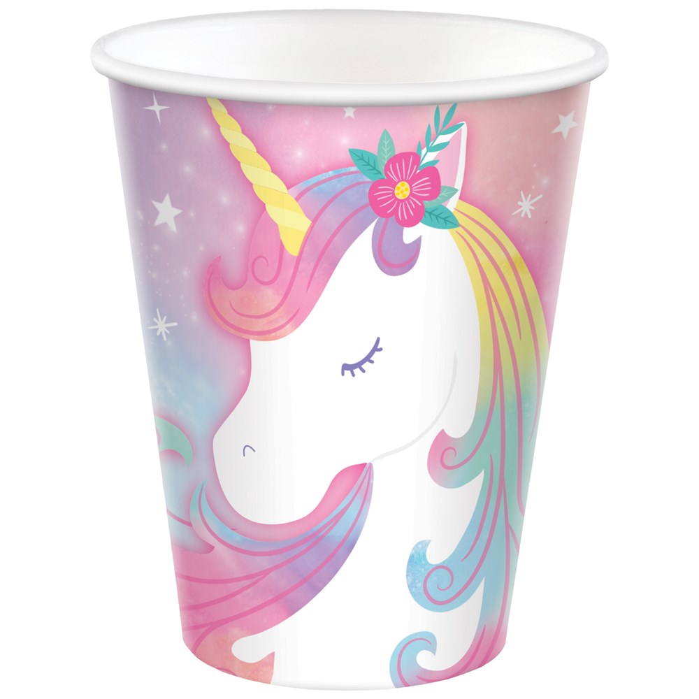 Pink paper cup with a white unicorn featuring a golden horn, closed eyes, rainbow mane, and floral accents.