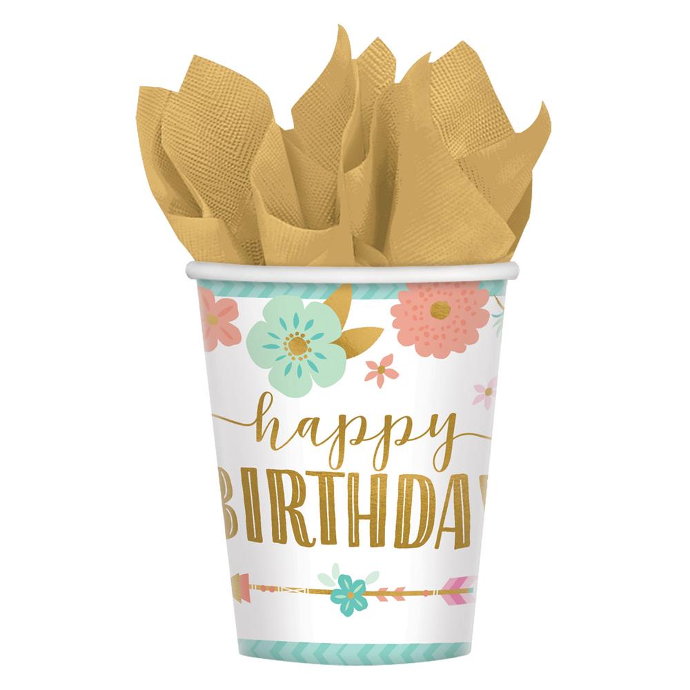 White paper cup with "happy BIRTHDAY" in gold and pastel floral designs, filled with tan napkins.
