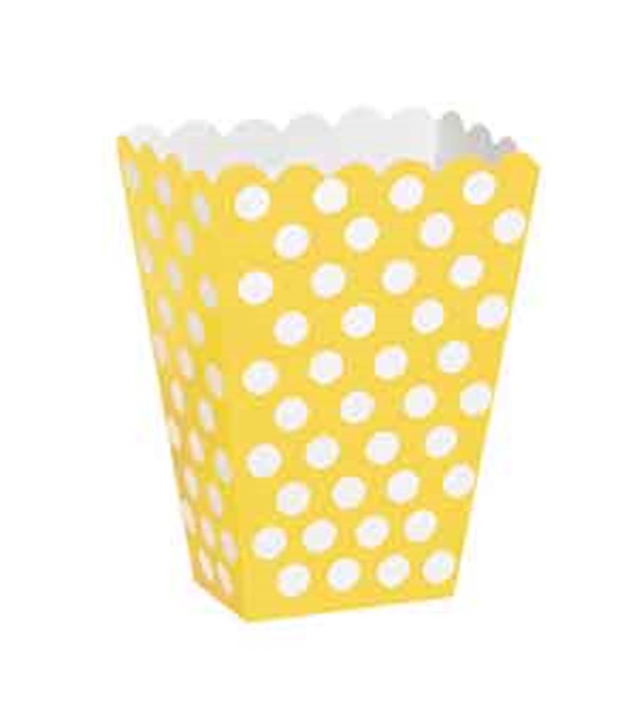 Yellow treat box with white polka dots and scalloped top edge, paper material.