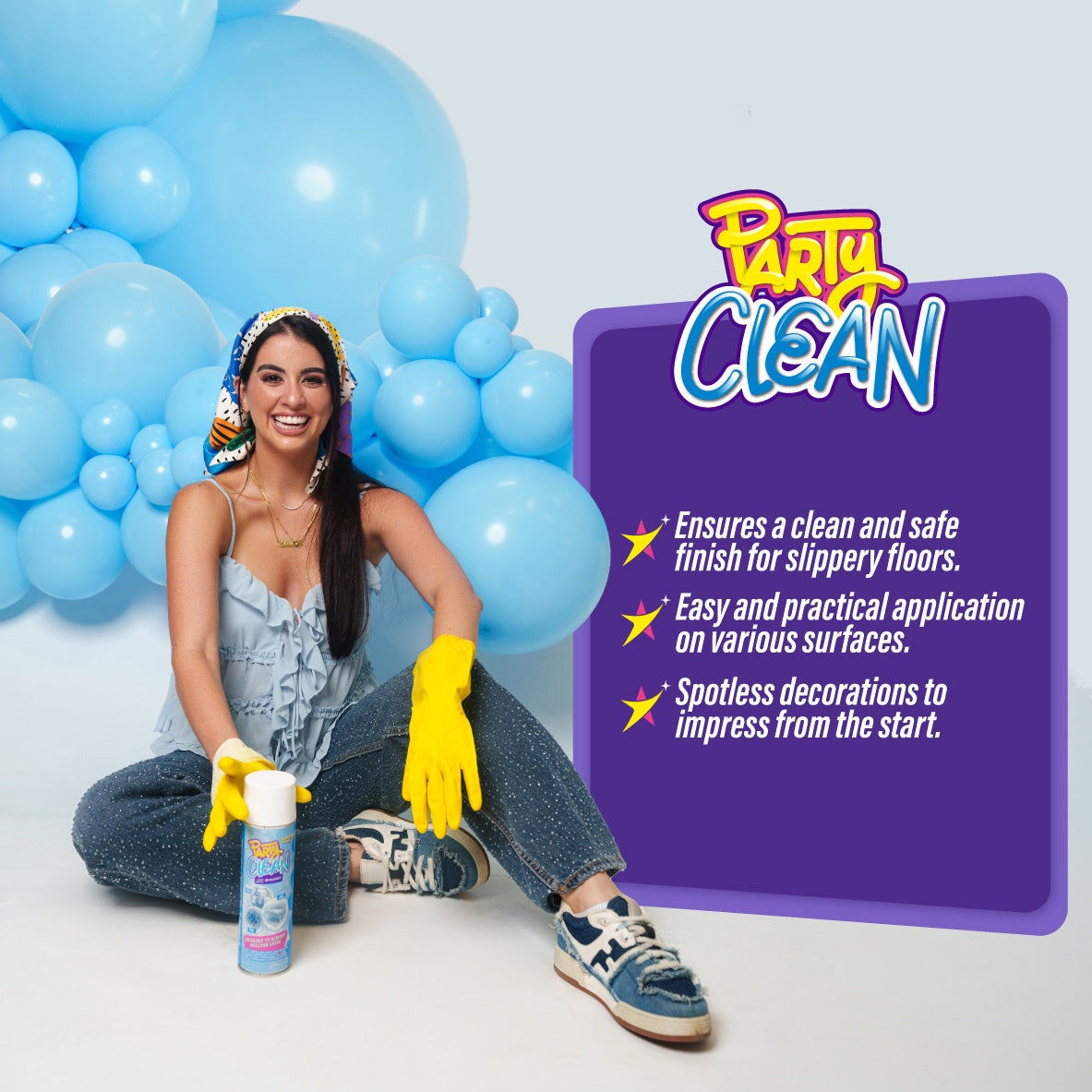 14oz clear spray bottle of Party Clean floor cleaner with purple label, held by woman wearing yellow gloves sitting amid.