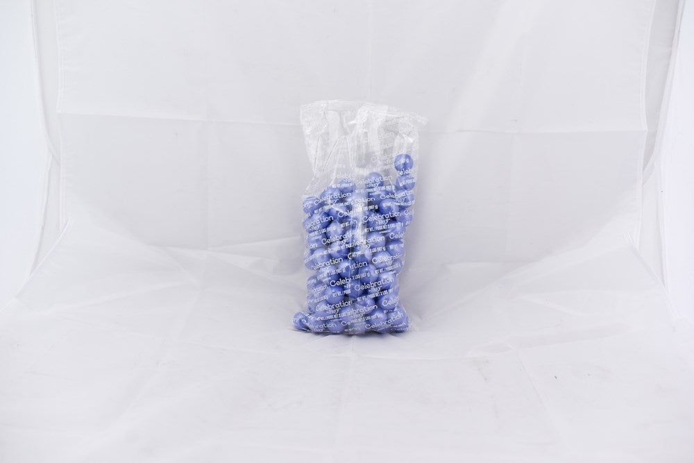 Clear plastic bag filled with small, round lavender-colored gumballs with a subtle shimmer.