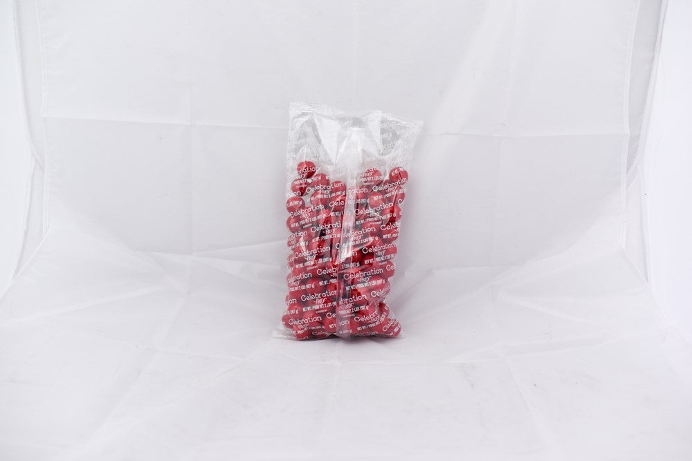 Clear plastic bag filled with bright red round gumballs, 2-pound size, glossy surface.