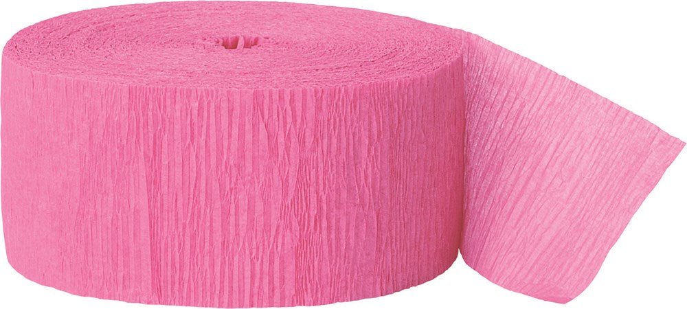 Bright pink crepe paper streamer roll with textured, crinkled surface, partially unrolled edge visible.