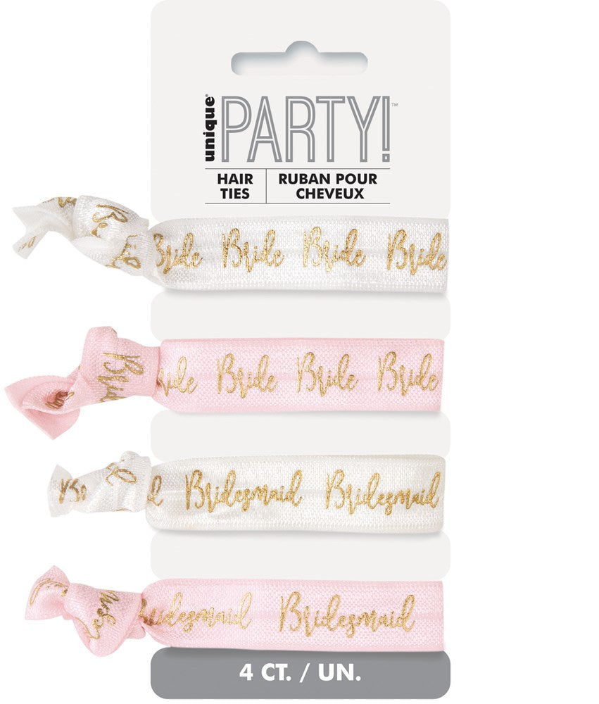 Set of four elastic hair ties in white and blush pink with gold foil text reading "Bride" and "Bridesmaid" in cursive.