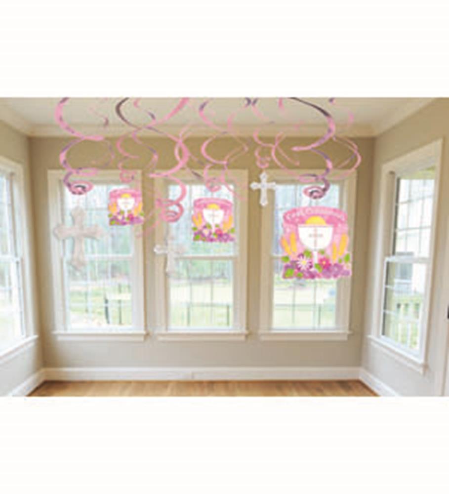 Pink and white swirl curling ribbons attached to pink and white small square boxes with religious-themed decorations hanging