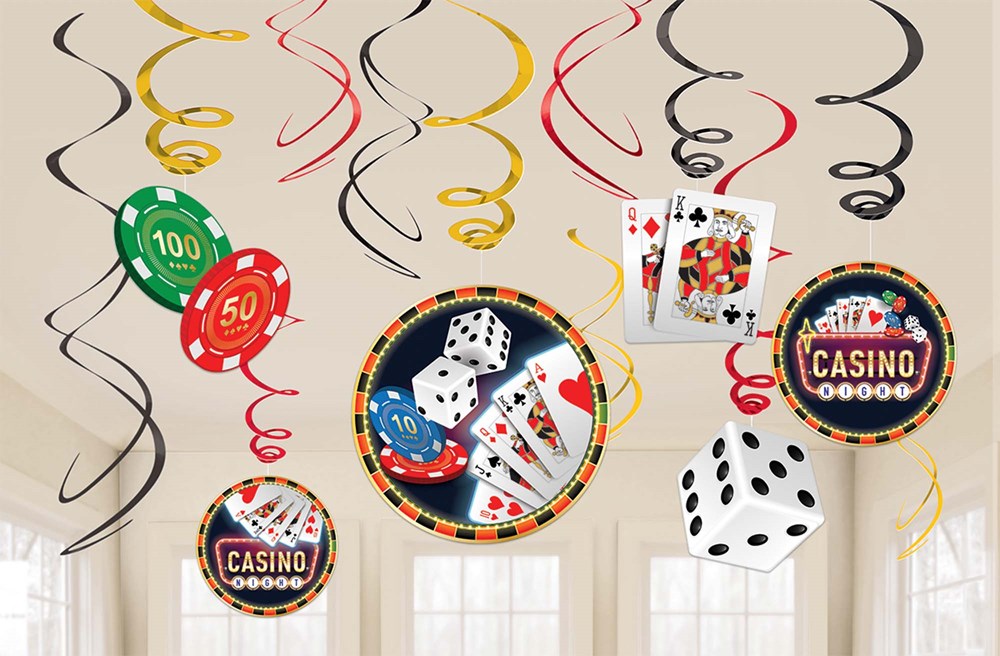 Casino-themed foil swirl decorations in red, yellow, and black with hanging poker chips, playing cards, dice, and casino.