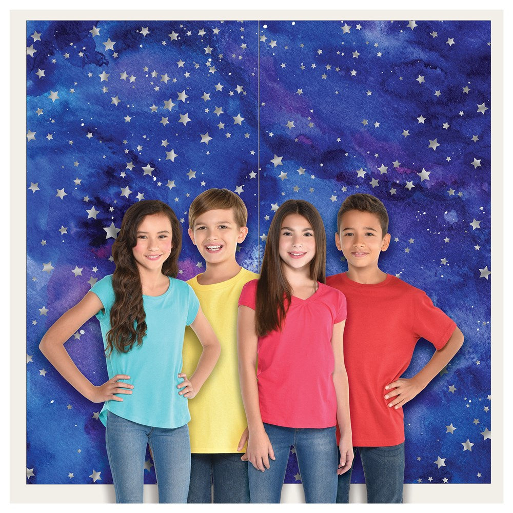 Two square party backdrops with blue and purple galaxy patterns, scattered with silver stars, shown behind four smiling.