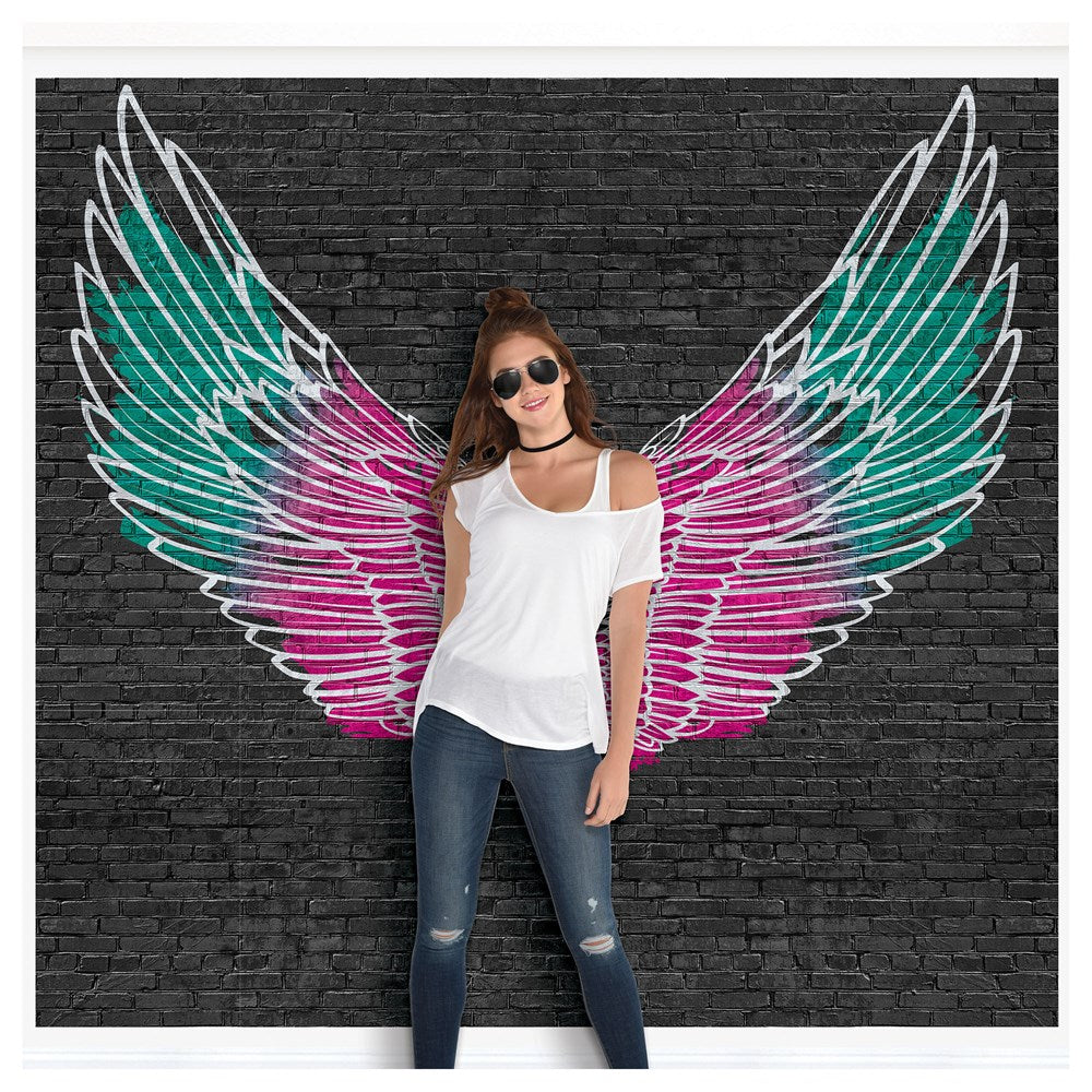 Colorful angel wings wall decals in turquoise, pink, and white on black brick background.