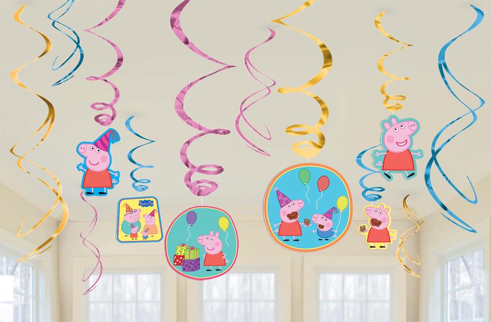 Colorful Peppa Pig swirl decorations with blue, pink, and yellow spirals and character cutouts hanging from ceiling.