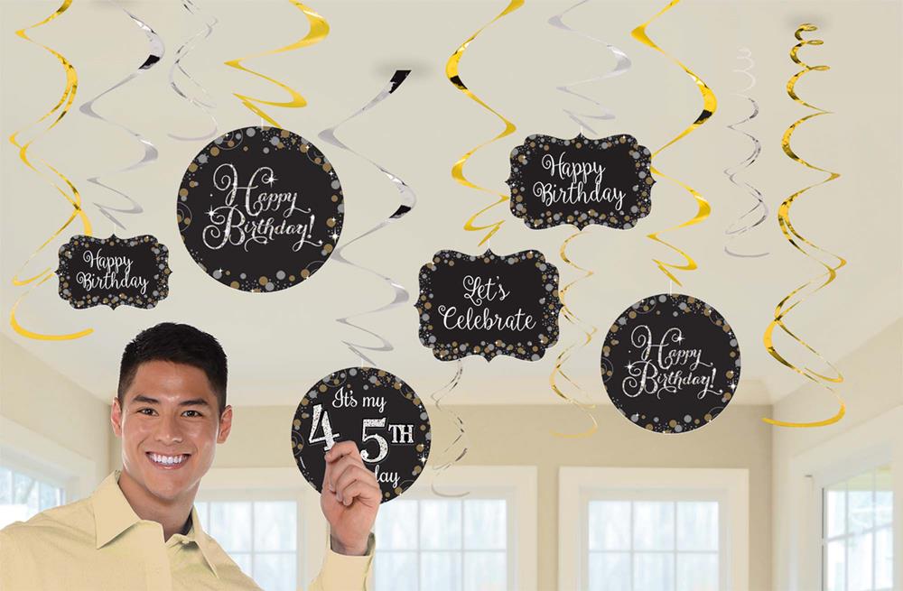Black and gold birthday swirl decorations with "Happy Birthday" and customizable age messages hanging from ceiling.