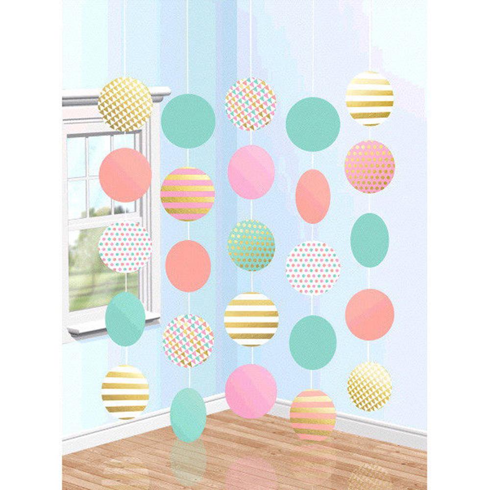 Pastel pink, teal, and yellow hanging circle decorations with striped, polka dot, and solid patterns in five strands.