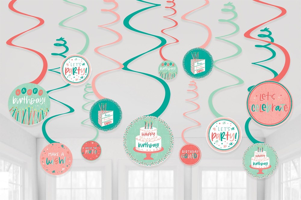 Colorful spiral hanging decorations with birthday-themed circular cutouts in pink, teal, red, and white.