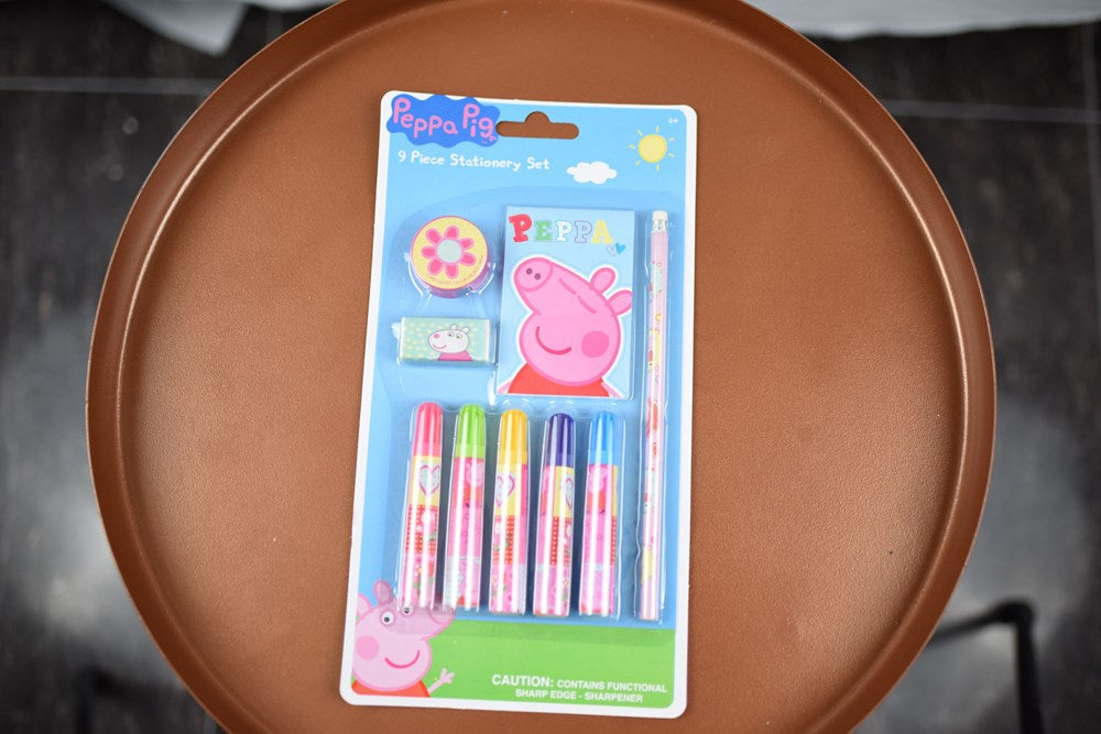 Peppa Pig 9-piece stationery set with markers, sharpener, eraser, and ruler in blue packaging.