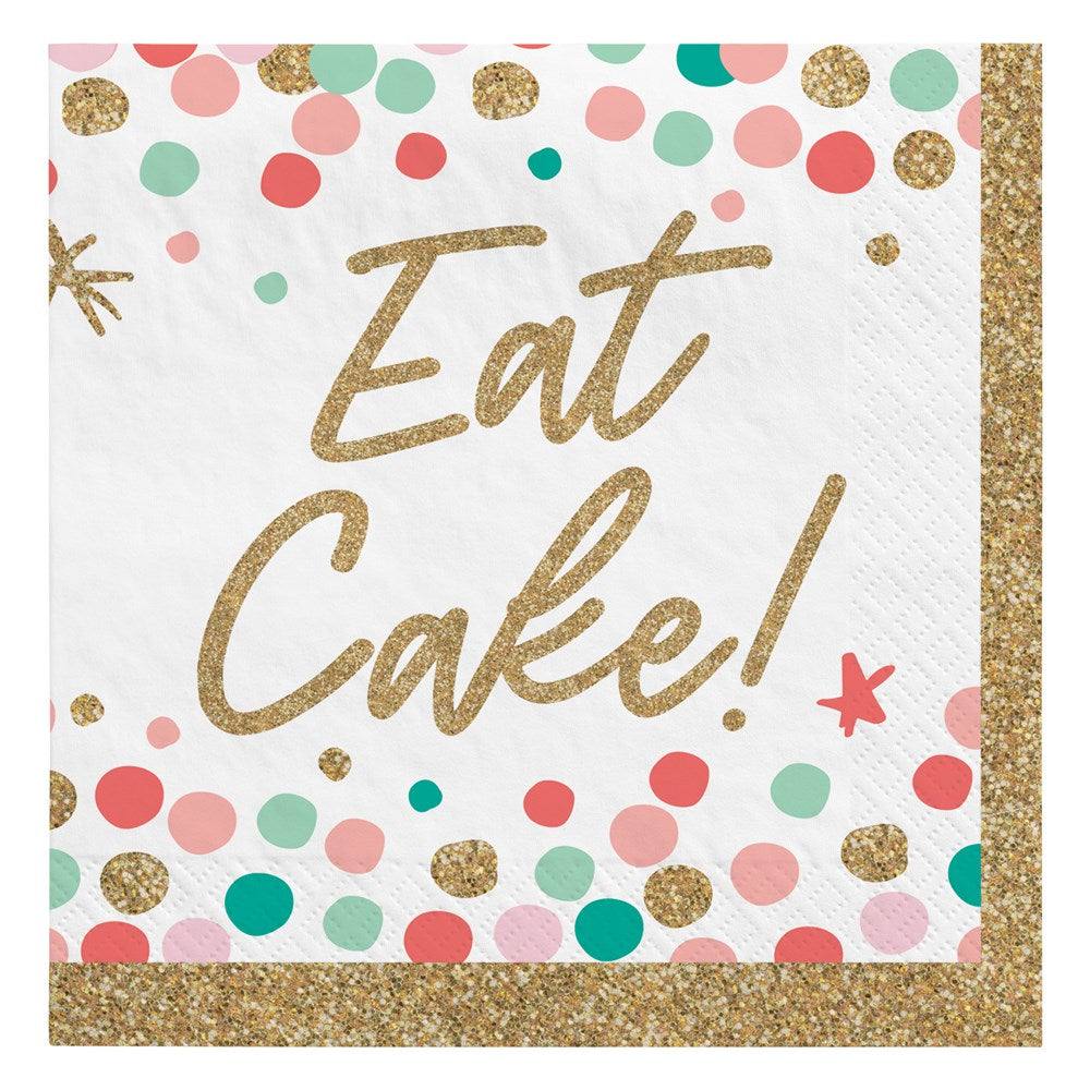 Square white beverage napkin with multicolored pastel and gold glitter confetti, gold glitter border, and "Eat Cake!" in.