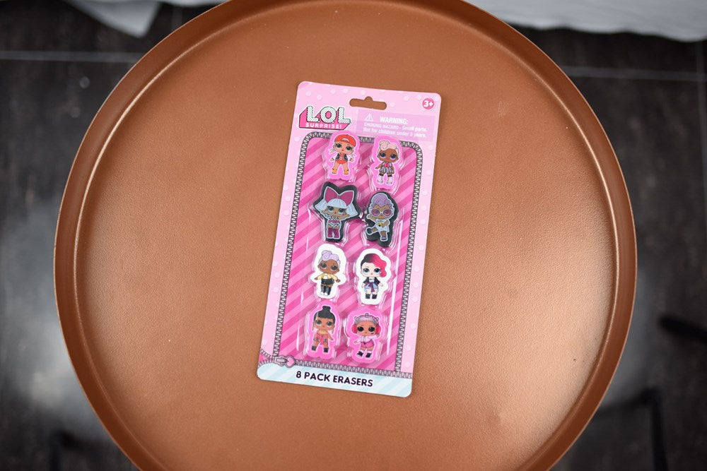 Set of eight LOL Surprise character erasers in pink packaging with playful designs.