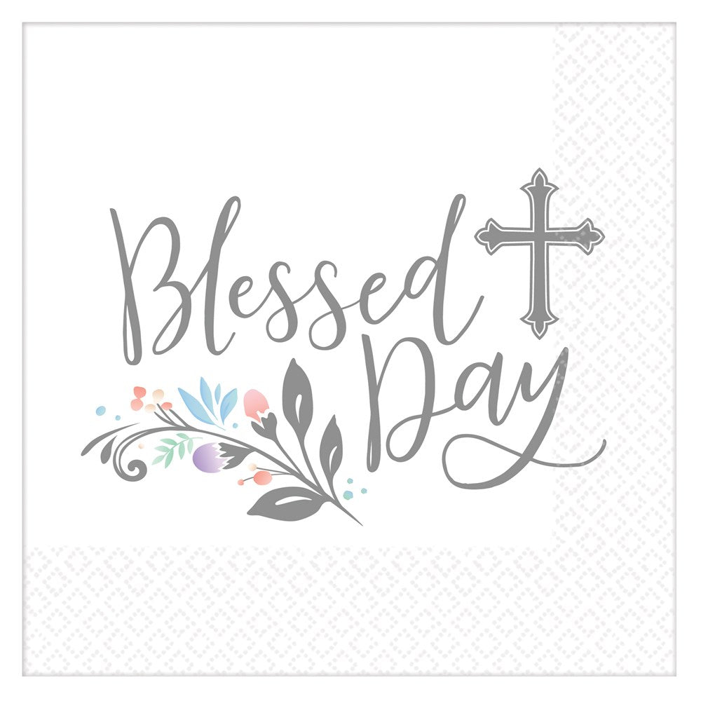 White luncheon napkin with "Blessed Day" in gray script, decorated with a gray cross and pastel floral accents at the bottom