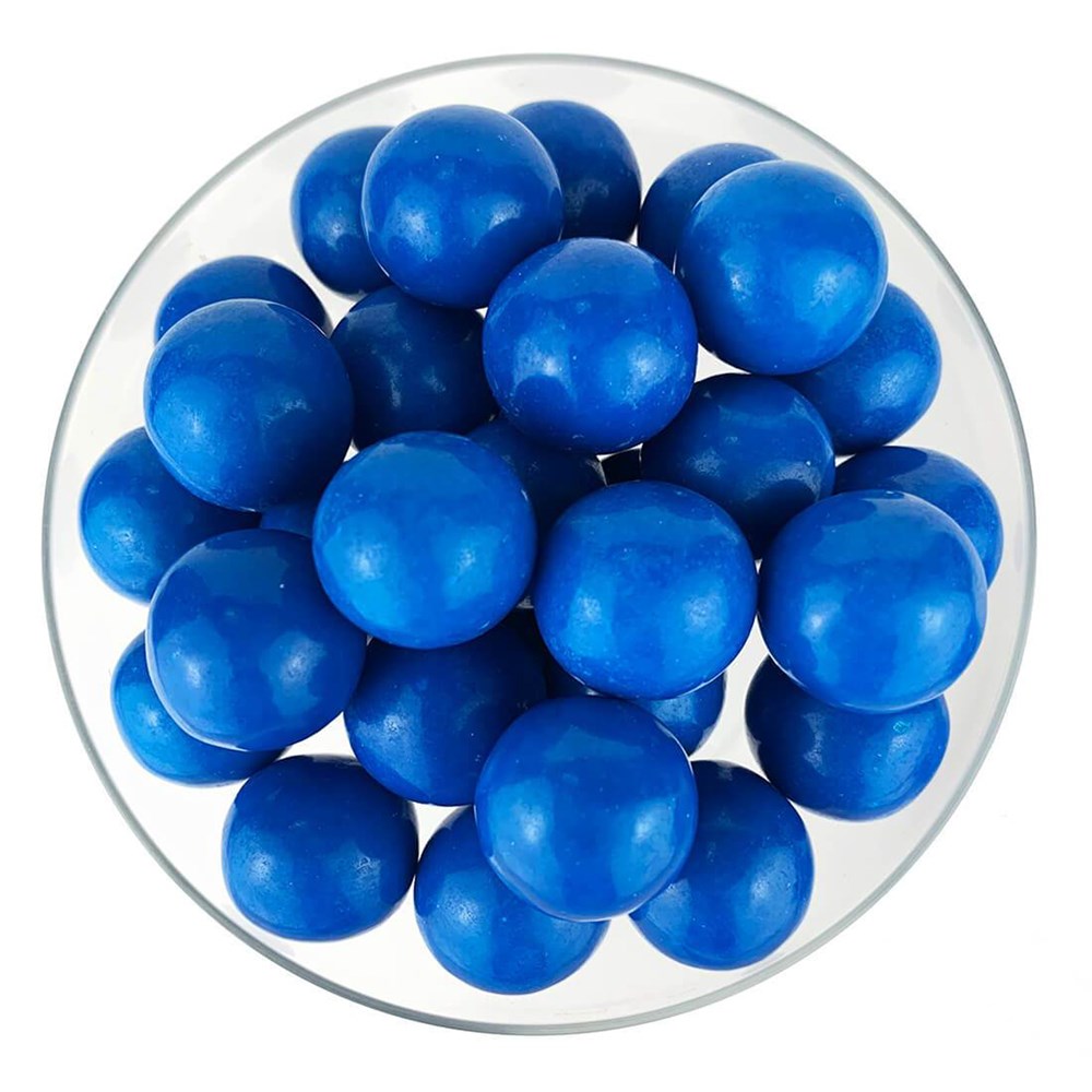 Bright blue, round, glossy gumballs piled in a clear bowl with smooth surfaces.