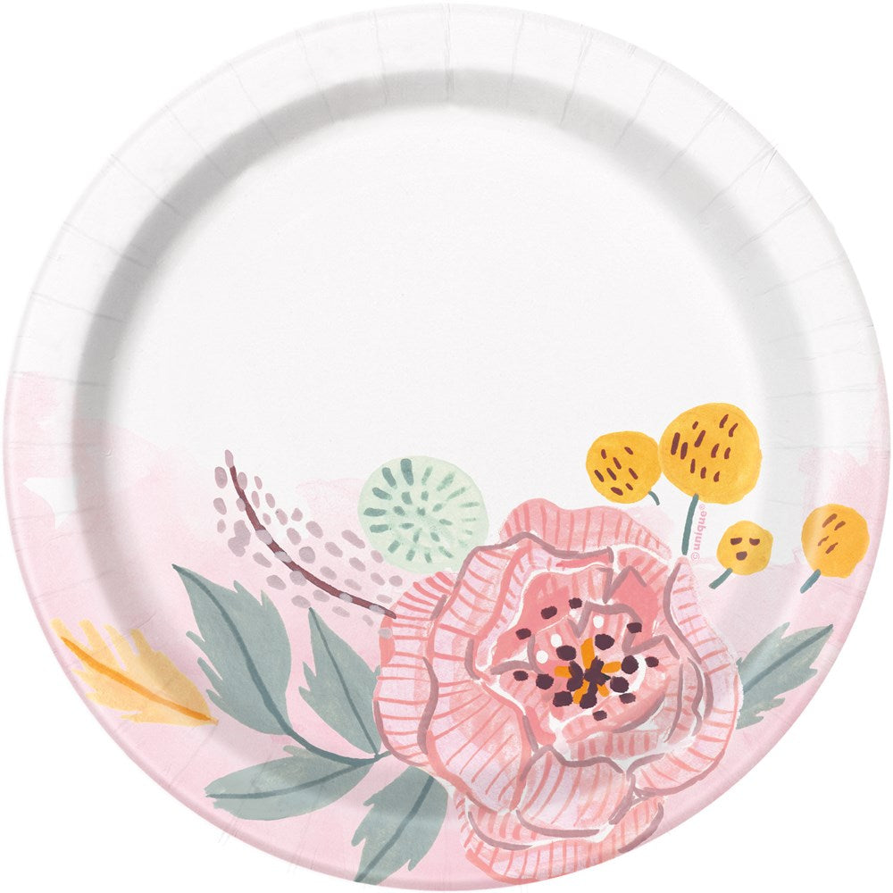 White round paper plate with pink, yellow, and green floral illustrations around the edge.