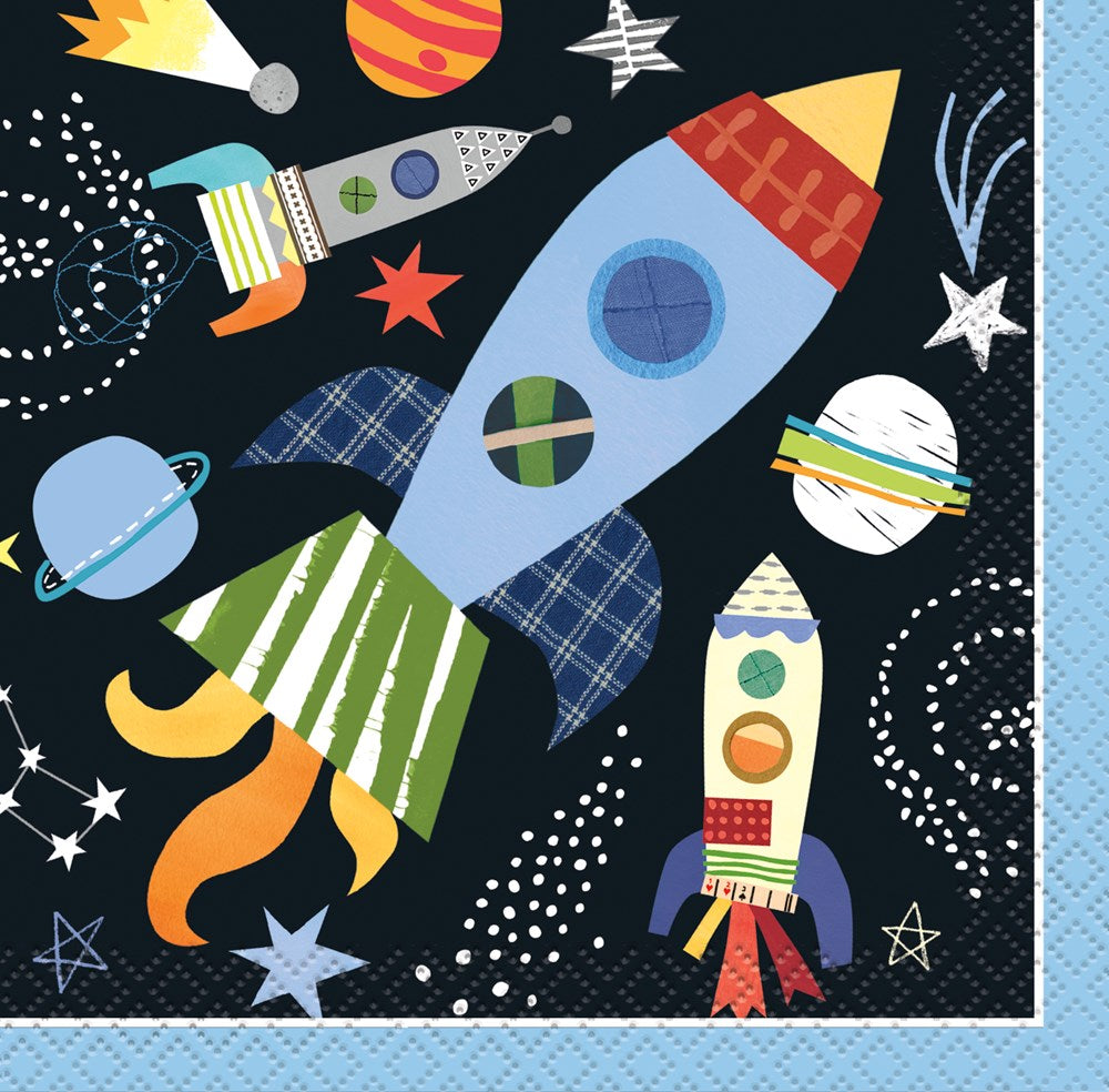 Colorful outer space beverage napkin with rockets, planets, stars, and swirling white dots on a dark background.