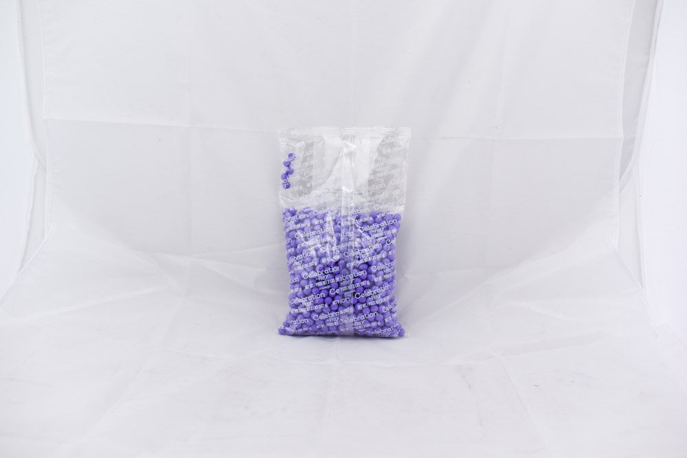 Clear plastic bag filled with small light purple beads labeled SiXLets, 2lb weight.