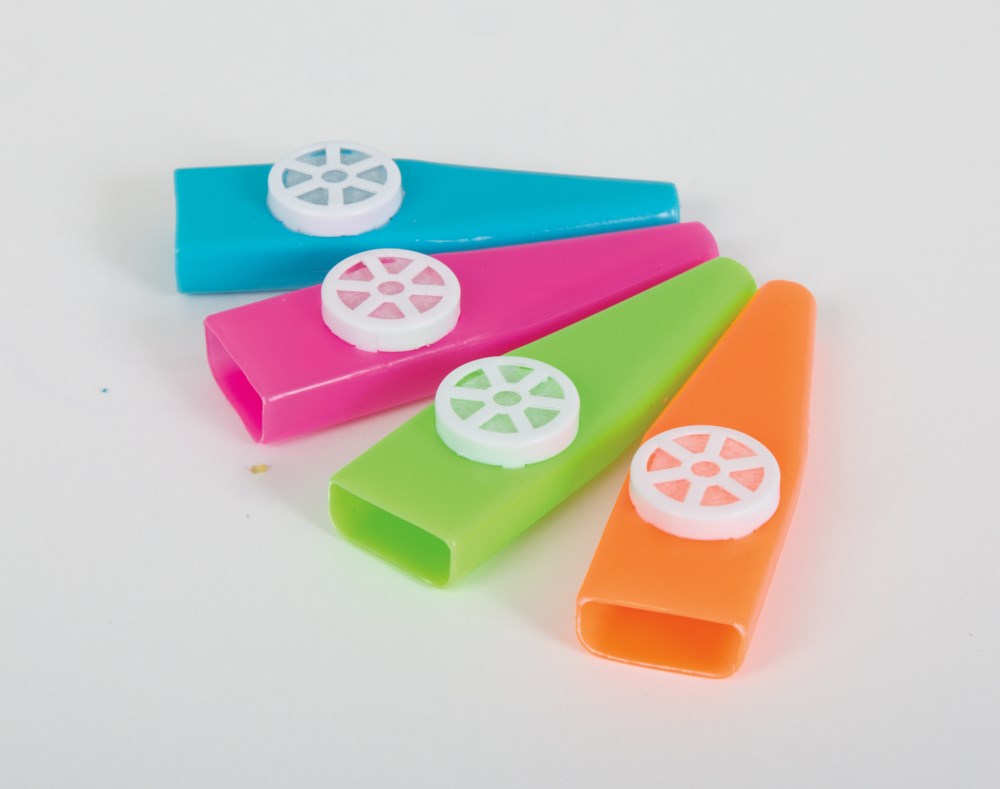 Set of four colorful plastic kazoos in blue, pink, green, and orange with white circular reeds.