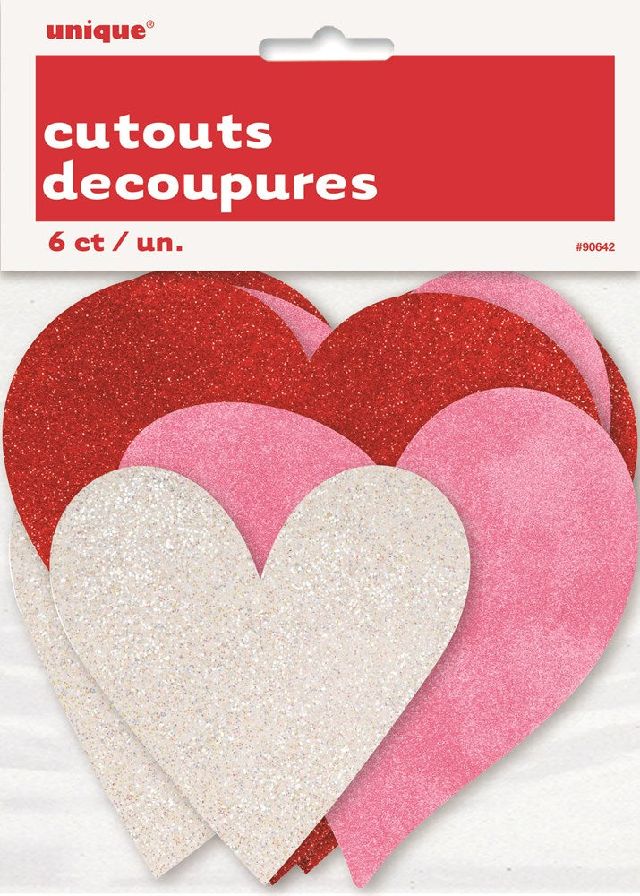 Six glittery heart-shaped cutouts in red, pink, and white, varying sizes, festive decor.