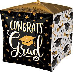 15-inch cube-shaped foil balloon with black, white, and gold graduation-themed design and congratulatory text.