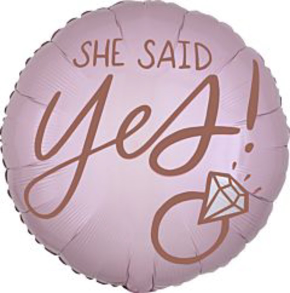 Round blush pink foil balloon with rose gold text "She Said Yes!" and a diamond ring graphic.