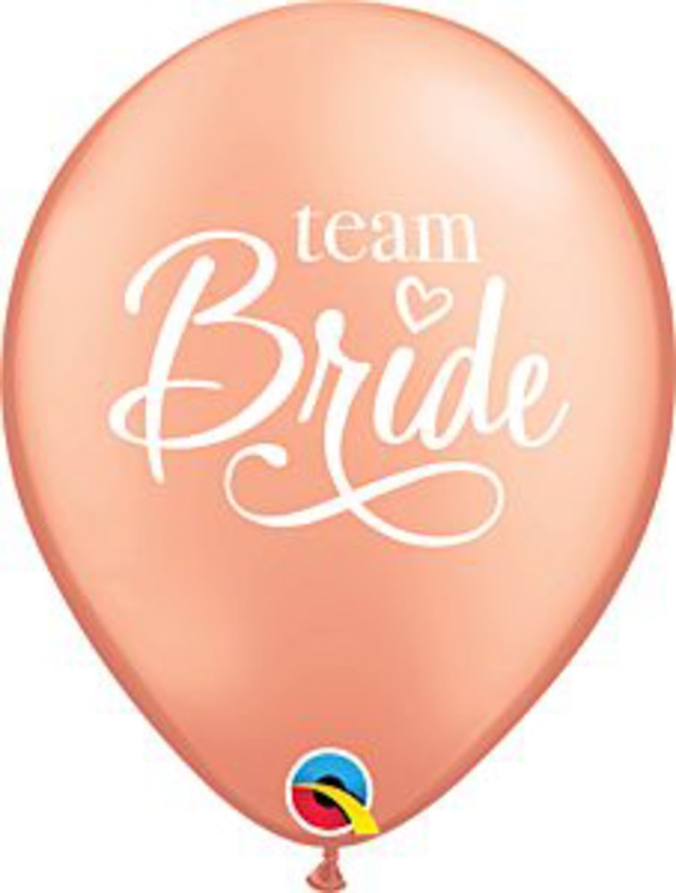 Peach-colored latex balloon with white "Team Bride" text and decorative heart detail.