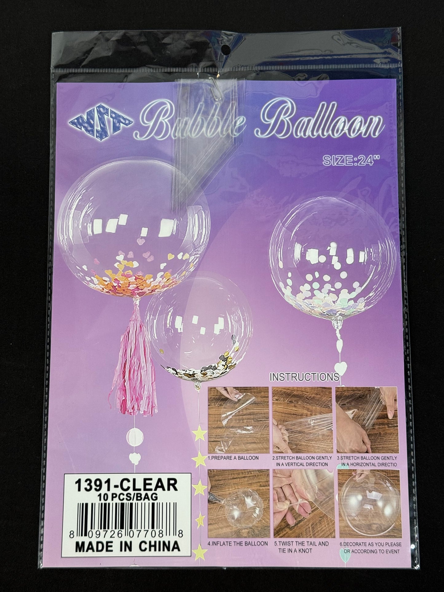 Clear 24-inch round bubble balloon with confetti inside and pink tassel tail, sealed in packaging.