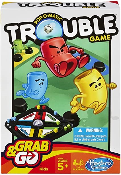 Trouble board game box with colorful red, blue, and yellow character pawns and black game pieces on white background.