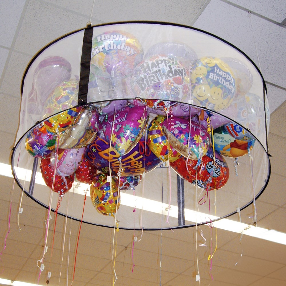 Circular silver frame balloon corral filled with colorful helium balloons featuring birthday designs.