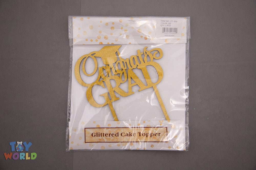 Glittered gold cake topper with cursive "Congrats Grad" text and two prongs for inserting.
