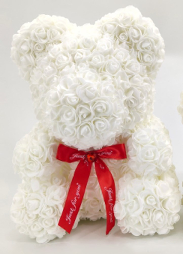 15in teddy bear made of white foam roses with a red ribbon bow around its neck.