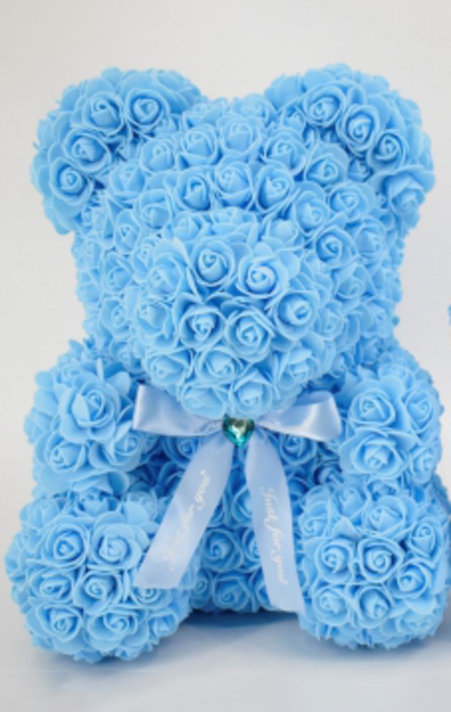 15-inch teddy bear shape made of sky blue foam roses with a blue satin bow and jewel centerpiece.