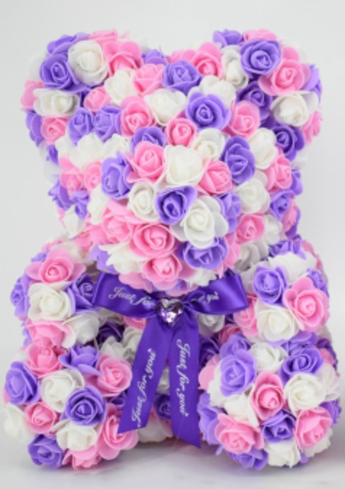 15-inch teddy bear made of purple, pink, and white foam roses with a purple ribbon around its neck.