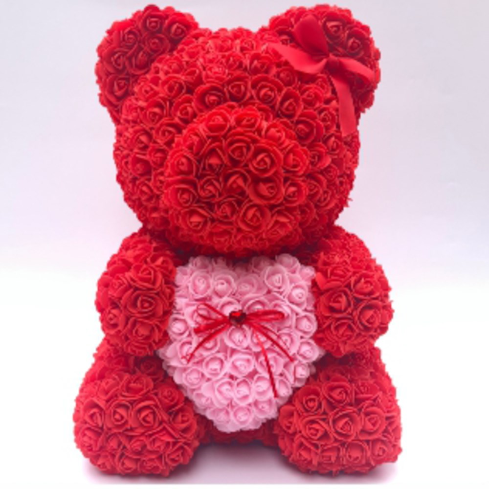 Red teddy bear made of foam roses with a large pink heart on its chest and a small red bow.