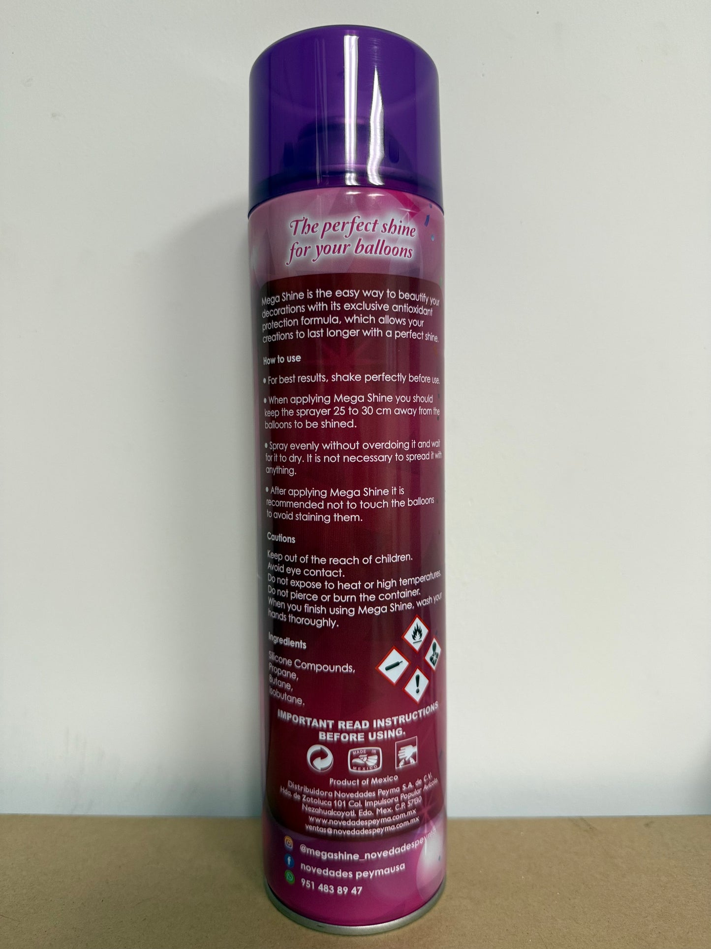Tall cylindrical purple aerosol can with white and silver text detailing instructions and warnings.