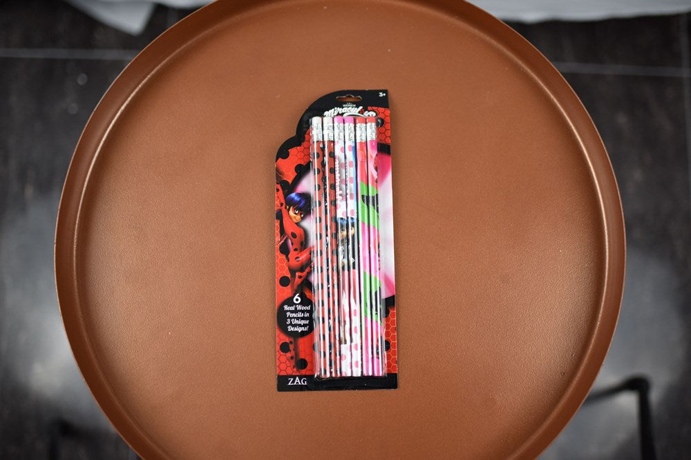 Set of six wooden pencils featuring colorful Miraculous Ladybug character designs in red, black, and pink shades with.