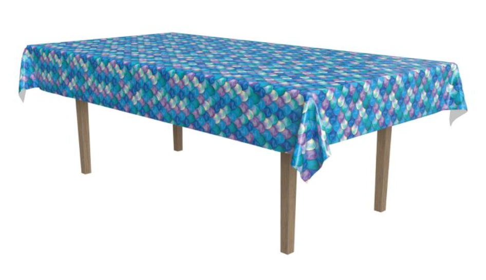 Blue, purple, and teal mermaid scale patterned rectangular plastic tablecover draped over wooden legs table.