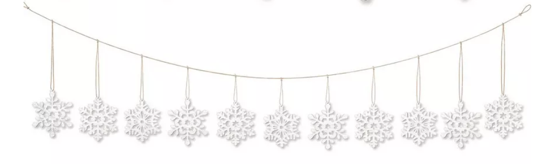 White wooden snowflake garland with ten intricately cut snowflakes hanging on natural twine string.