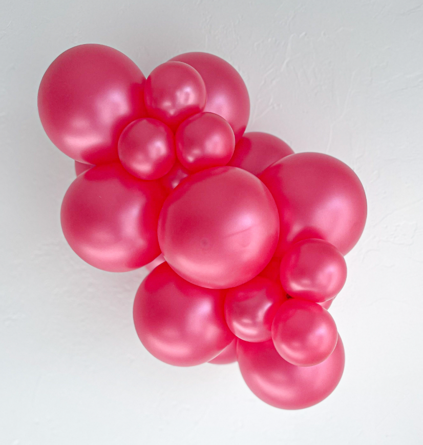 Cluster of shiny metallic fuchsia latex balloons in varying sizes forming an 11-inch decorative arrangement.