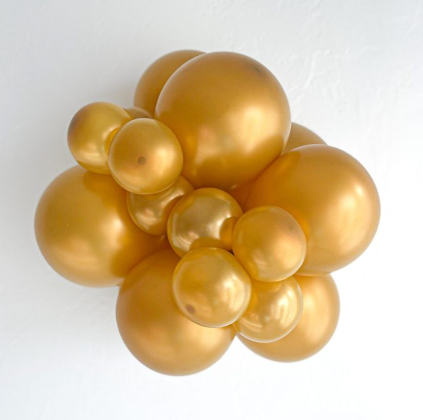 Cluster of shiny metallic gold latex balloons in various 5-inch sizes against a white background.