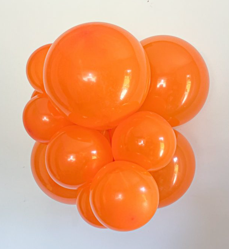 Cluster of glossy orange latex balloons in various sizes, round shape, vibrant tangerine color.