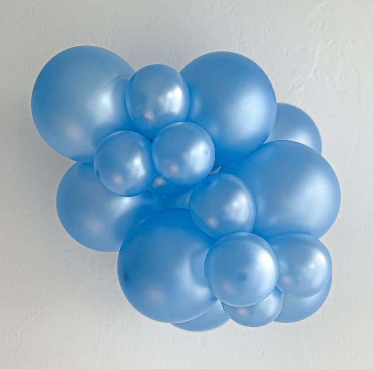 Cluster of sky blue pearlized latex balloons in varying sizes forming a decorative arrangement.