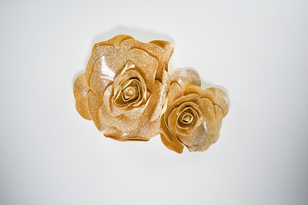 Two champagne metallic wall flowers, one 12-inch and one 16-inch, with layered petal design.