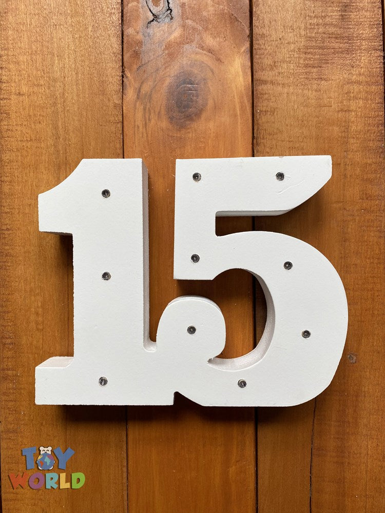 White wooden number 15 with six small built-in light bulbs on a wooden background.
